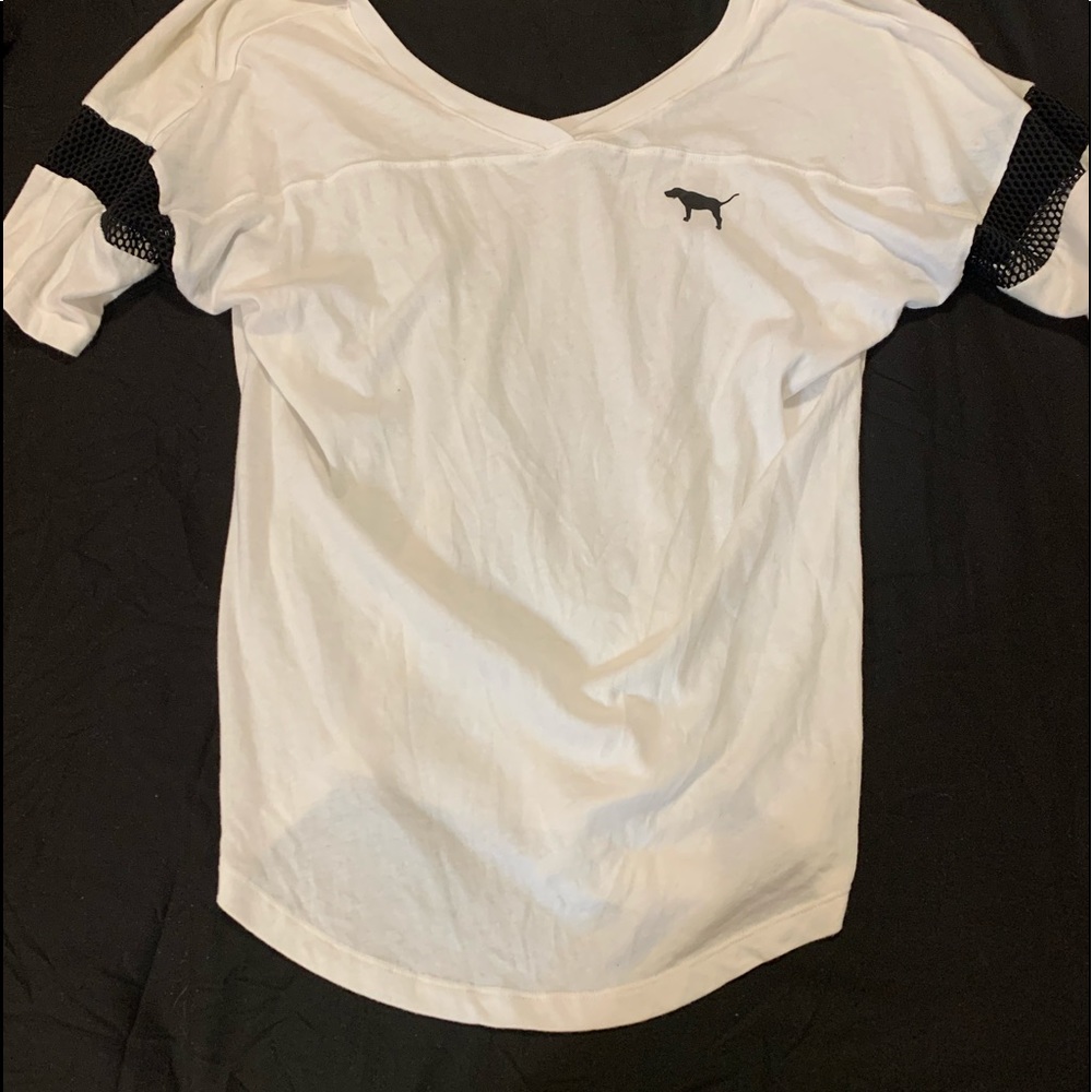 Mainly white shirt with black material in certain spots.